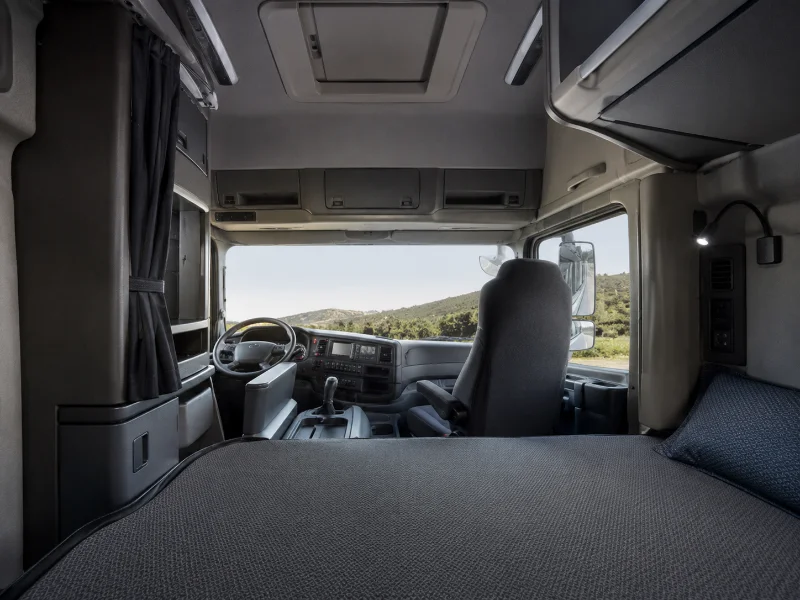 Interior of a Shacman X3000 sleeper cab configured for high-mileage long-haul driver comfort